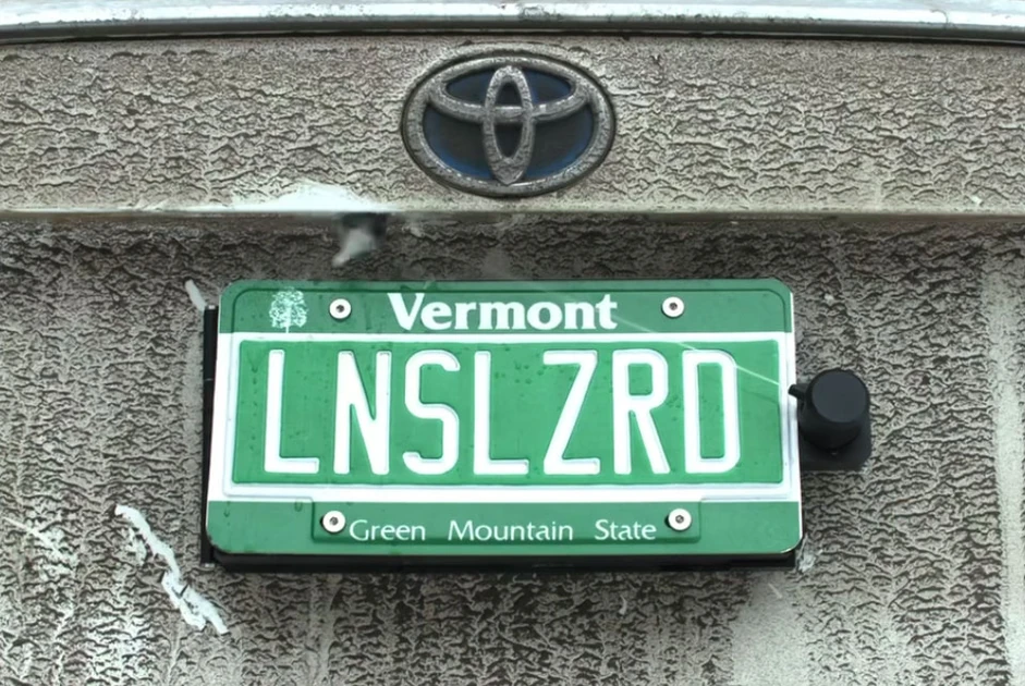 This backup camera cleaner hides behind your license plate