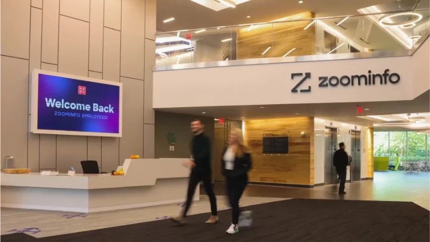 ZoomInfo beat earnings, cut 600 jobs, and lost 29 per cent of its stock price. Its database is being repriced by AI.